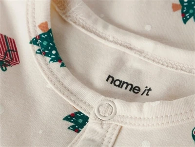 Detalje af whitecap gray natsuit fra Name It med juleprint