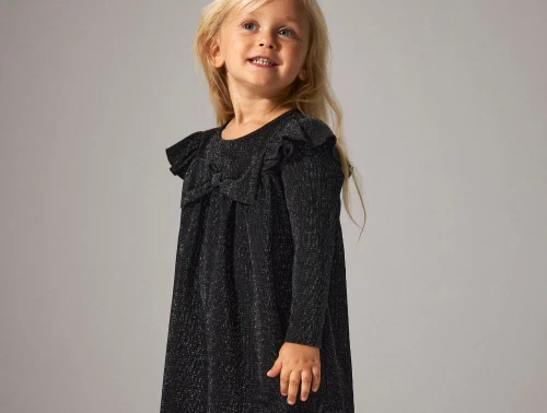 Pige i sort glimmerkjole fra Name It med sløjfedetalje