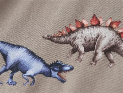 Name It bluse i grønlig beige nuance vintage khaki med dinosaurprint foran