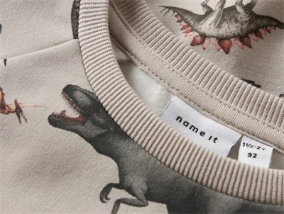 Name It sweatshirt i lys beige nuance pumice stone med allover dinosaurer