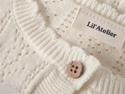 Lil Atelier cardigan i råhvid nuance med hulmønster detalje