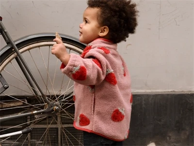 Pige iklædt Mikk-line teddy jakke strawberry aop med jordbærprint