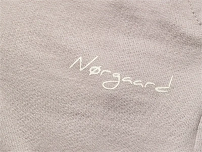 Nærbillede af logoprint på Mads Nørgaard sweatpants i atmosphere