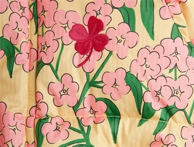 detaljebillede af rød broderet blomst på Mini Rodini pufferjakke