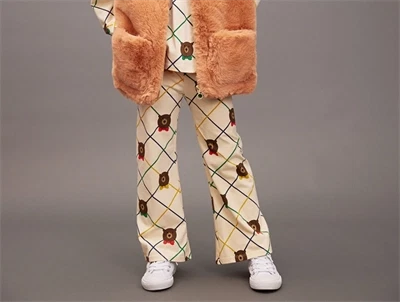 Barn med Mini Rodini flared bukser i råhvid med print