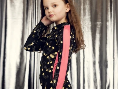 Pige iklædt Mini Rodini uv badedragt i black med starfall print